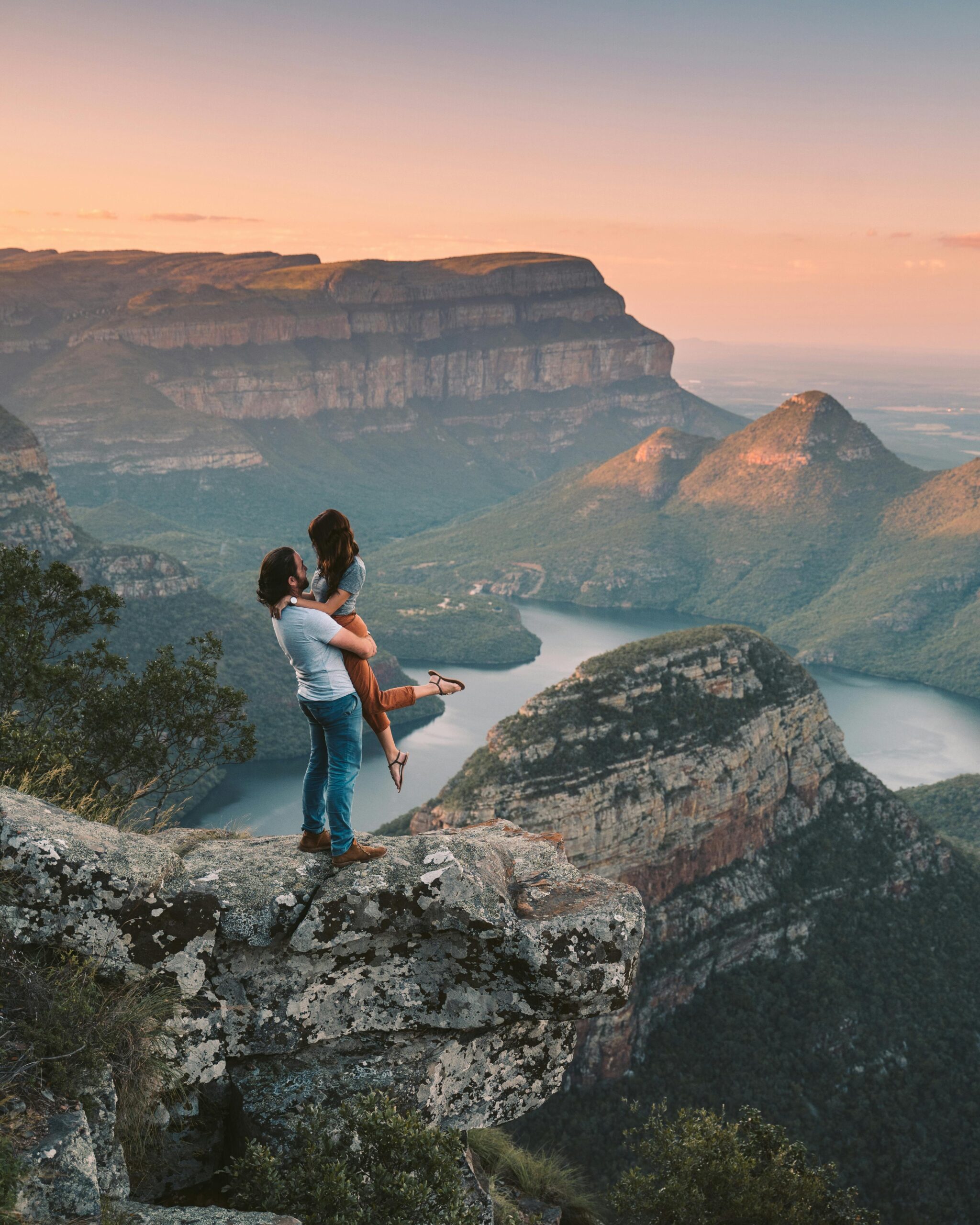 Couple embracing on a cliff